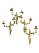 Set of four modern gilt brass two branch wall lights of rococo design, height of backplate 36cm,