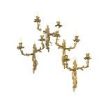 Set of four modern gilt brass two branch wall lights of rococo design, height of backplate 36cm,