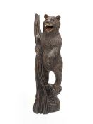 Black Forest carved wooden figure of a standing bear holding a branch H103cm