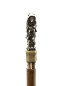 19th century Malacca walking cane, the white metal finial modelled as a Anthropomorphic Fox dressed