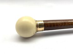 1920's snakewood walking cane with 9ct gold collar inscribed J.E.W dated 22.6.23 with spherical ivor