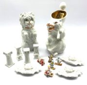 Various bisque Christmas cake decorations including Santa Claus, two figures skiing, winged Cherubs