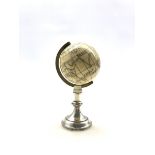 19th century ivory Terrestrial Globe with incised and black stained detail, with spun brass bezel a