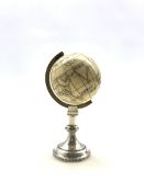 19th century ivory Terrestrial Globe with incised and black stained detail, with spun brass bezel a