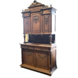 Early 20th century carved oak buffet, raised back with three cupboards supported by turned tapered a