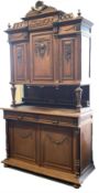 Early 20th century carved oak buffet, raised back with three cupboards supported by turned tapered a