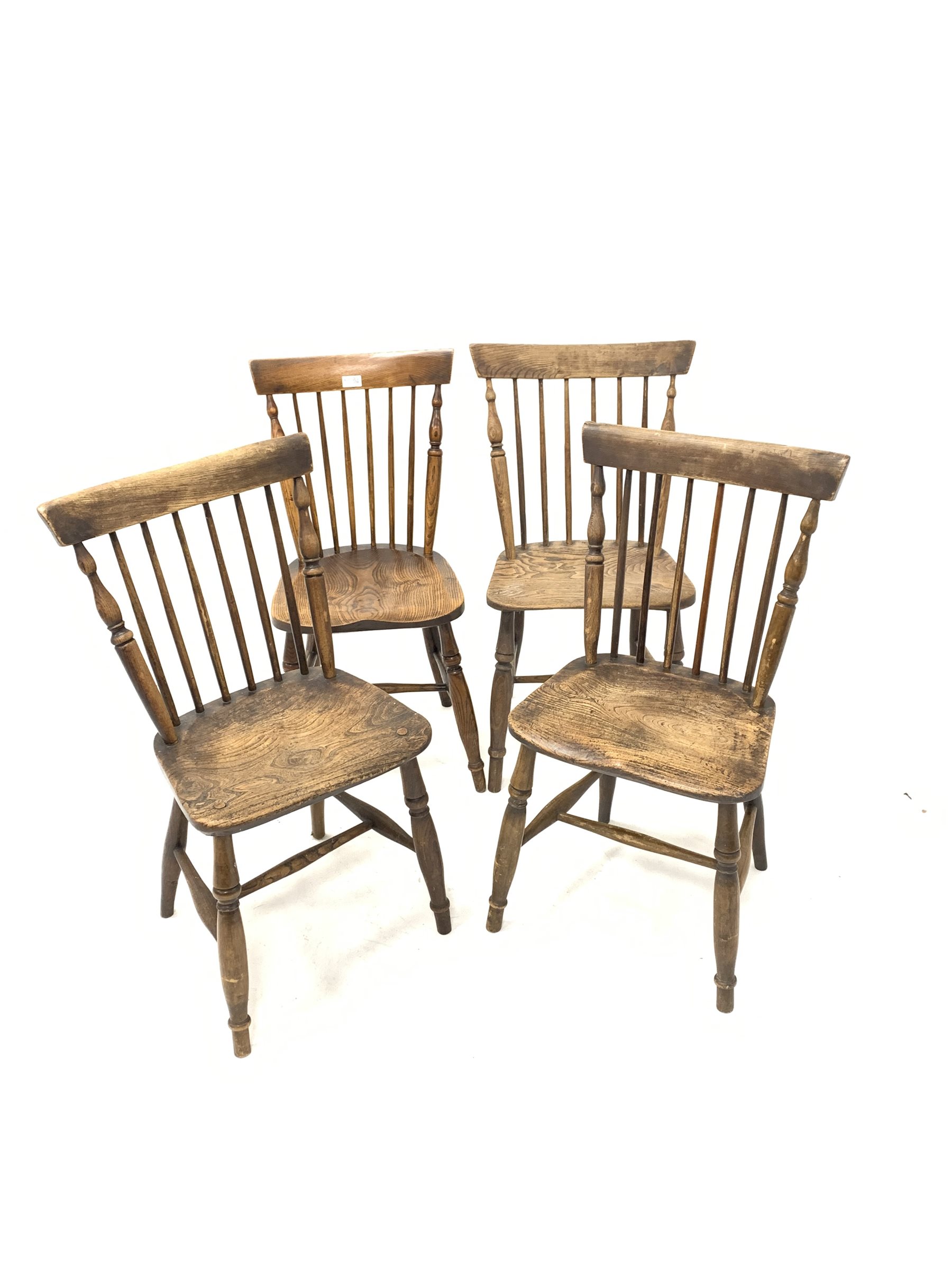 Matched set four elm spindle back dining chairs, with saddle seats, raised on turned supports and st