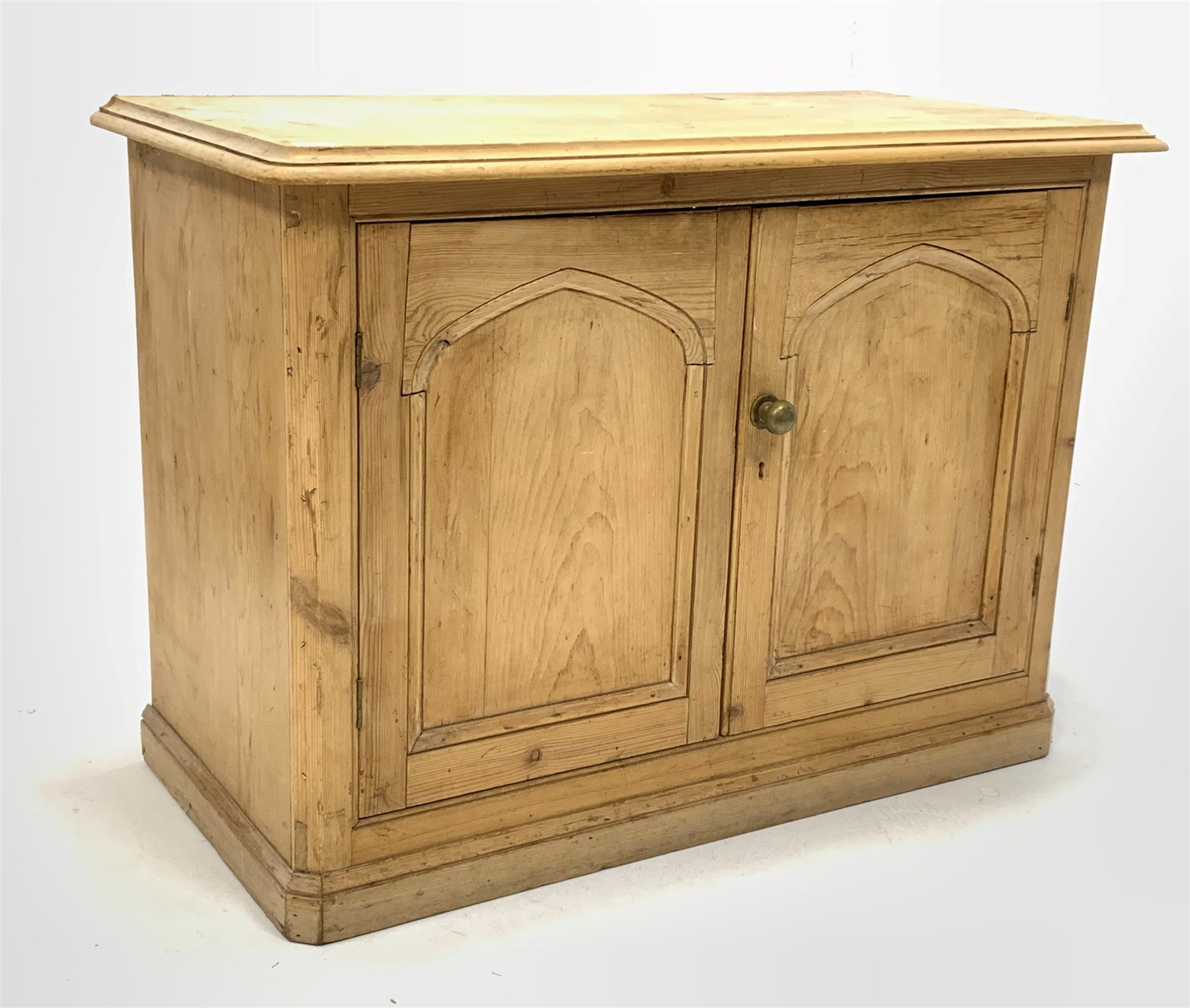 Victorian pine side cabinet, moulded top over double fielded panelled doors enclosing shelves, skirt