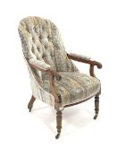 Late Victorian walnut framed open armchair, upholstered in buttoned fabric, floral scroll carved arm