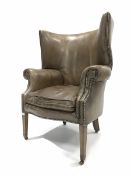 Georgian design barrel back wing armchair, upholstered in studded tan leather, with squab cushion, r