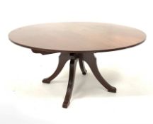 Georgian style mahogany circular dining table, raised on four reeded splayed supports