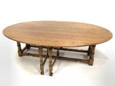 17th century style drop leaf wake dining table, the oval top raised on ring turned and block support