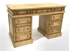 Early 20th century pine twin pedestal desk, the top section fitted with three drawers, over two bank