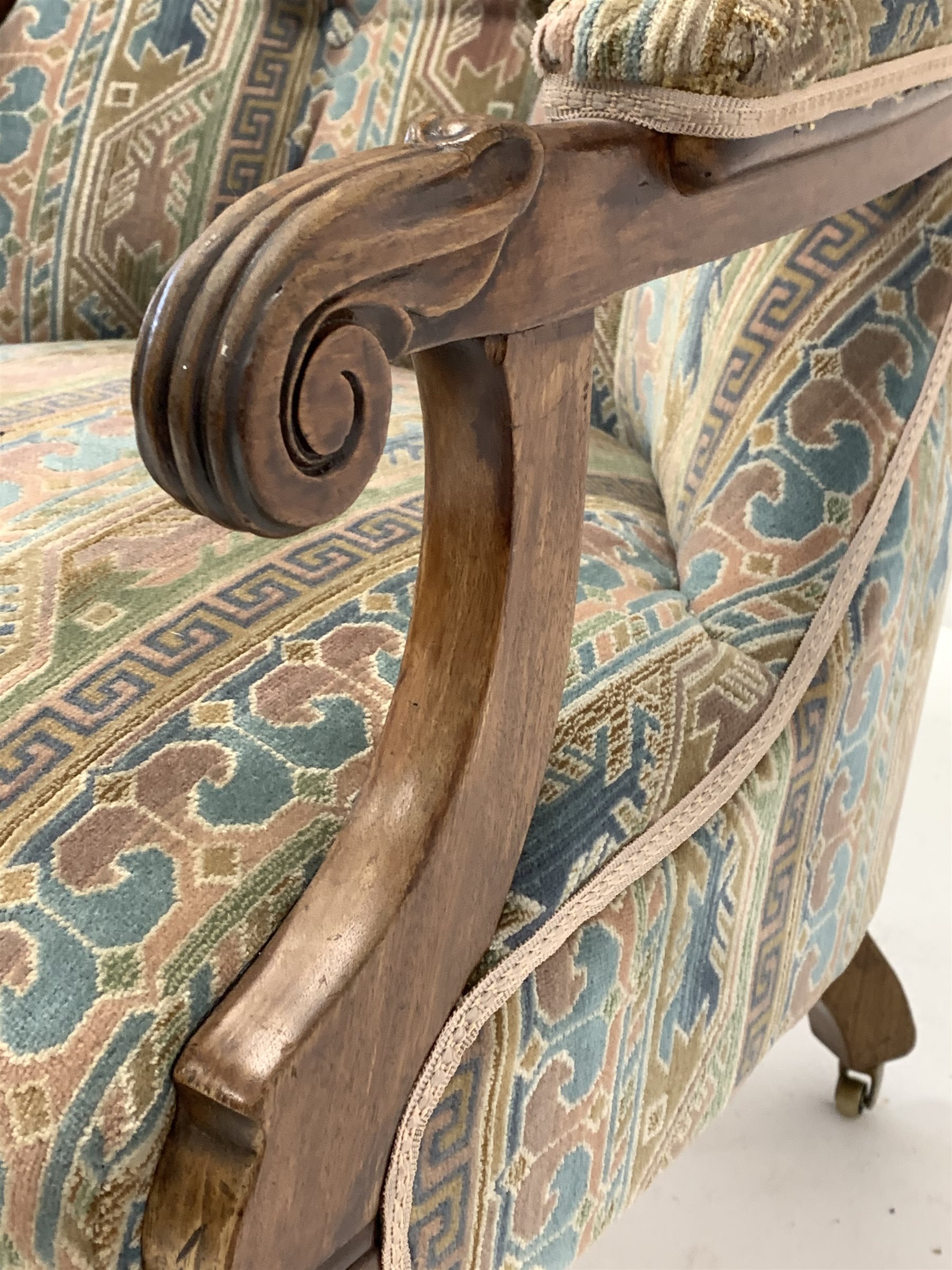 Late Victorian walnut framed open armchair, upholstered in buttoned fabric, floral scroll carved arm - Image 3 of 3