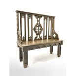 19th century oak hall bench of Gothic design, with arched splats carved with fleur de lis, chamfered