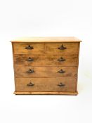 Early 20th century varnished pine chest, fitted with two short and three long graduated drawers