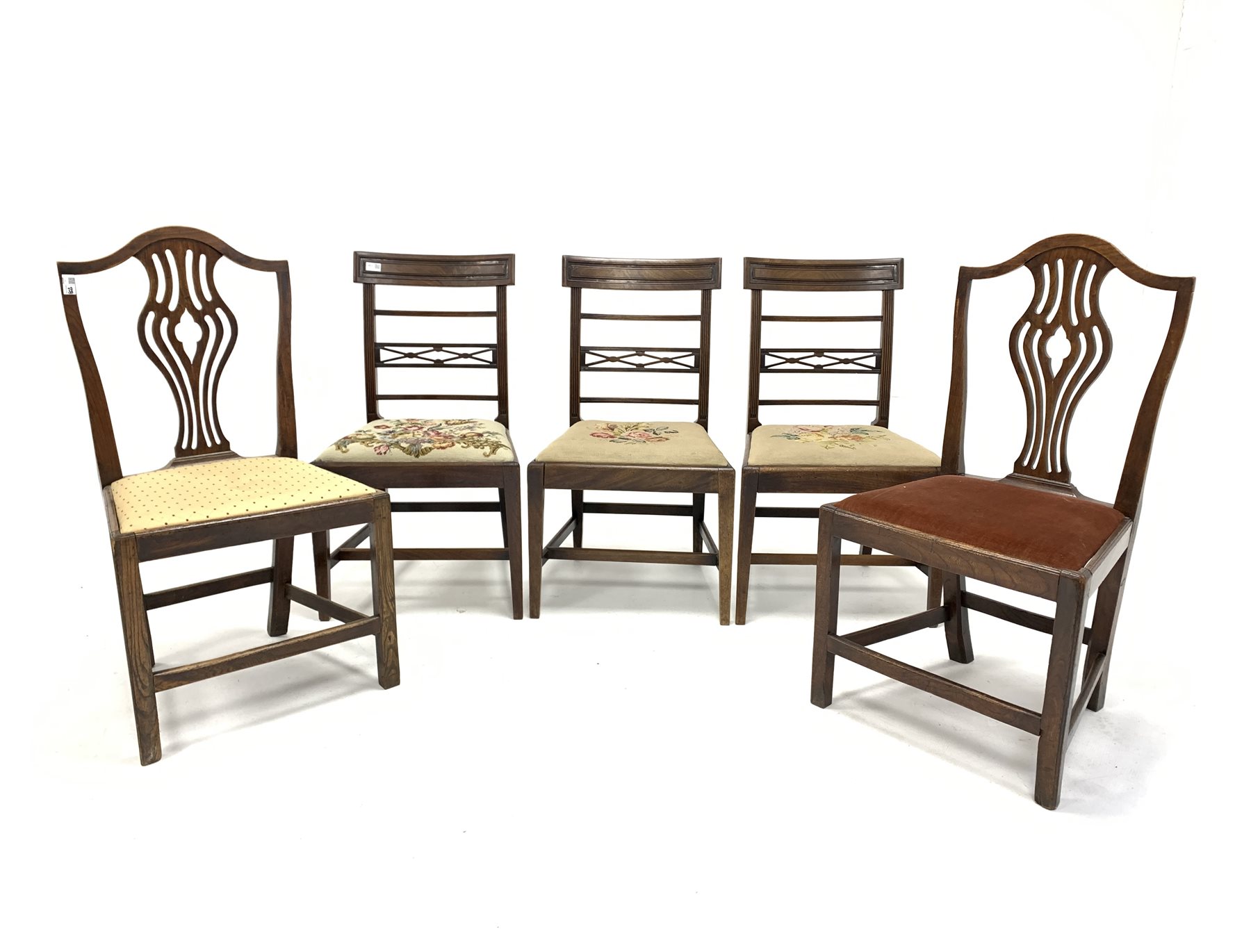 Set of three George III mahogany dining chairs, geometric carved crest rail over reeded rails and up