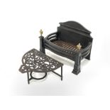 Cast iron fire grate with brass finials, (W50cm) and a 20th century demi lune cast iron footman (W39