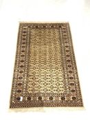 Persian design beige ground rug, lozenge motif enclosed by triple guarded border
