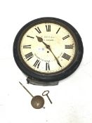 Late 19th century station clock, in circular ebonised case, white enamel dial with Roman chapter rin