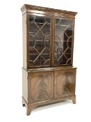 20th century Georgian design mahogany bookcase on cupboard, dentil cornice over double astragal glaz