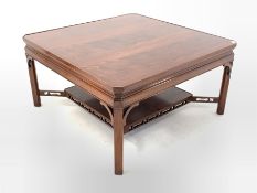 20th century mahogany coffee table, square top with canted corners raised on chamfered supports unit