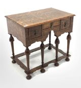 17th century style oak lowboy, fitted with three drawers, raised on turned supports united by shaped