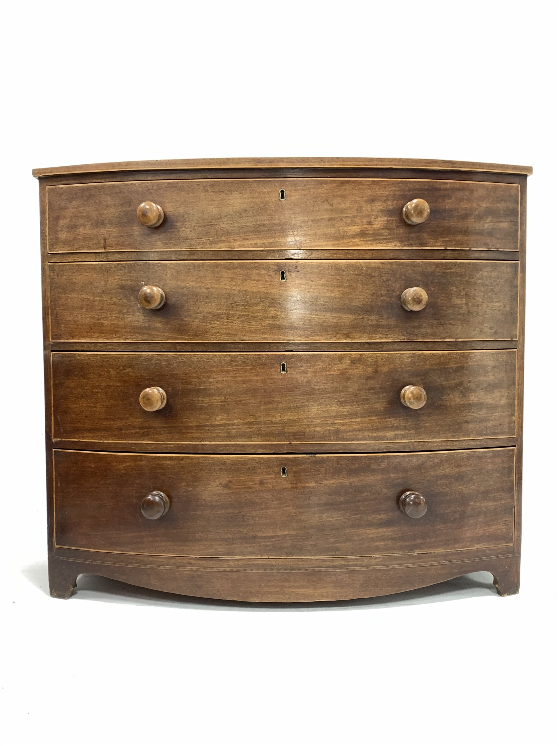 Early to mid 19th century mahogany and boxwood strung bow front chest fitted with four long graduate