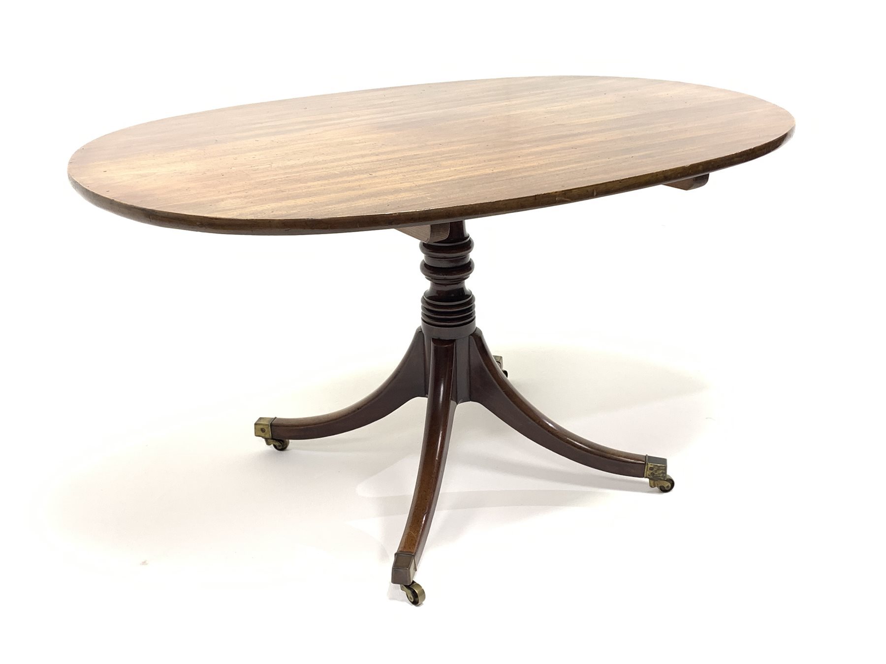 Georgian mahogany breakfast table, oval tilt top on turned pedestal base, four out splayed supports