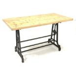 19th century industrial cast iron table, scrolled end supports united by three stretchers stamped 'T