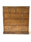 Early 20th century chest fitted with two short and three long graduated drawers, raised on a skirted