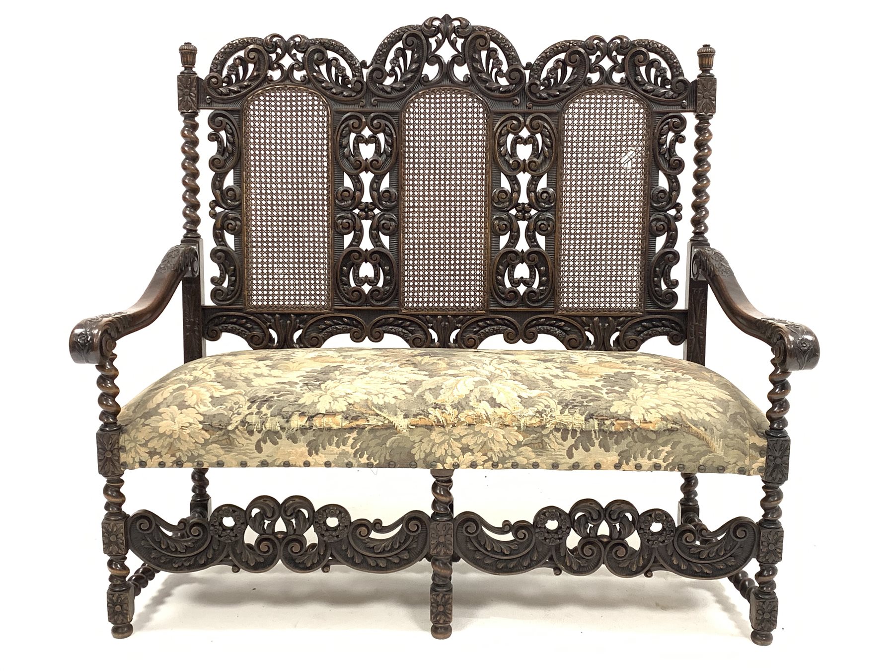 Early 20th century William and Mary style walnut hall seat, with cane panels to back, profusely carv