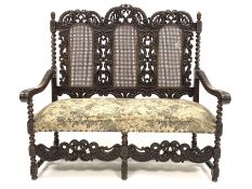 Early 20th century William and Mary style walnut hall seat, with cane panels to back, profusely carv