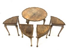 Early 20th century walnut nest of five tables, the larger circular table with pie crust top, and all