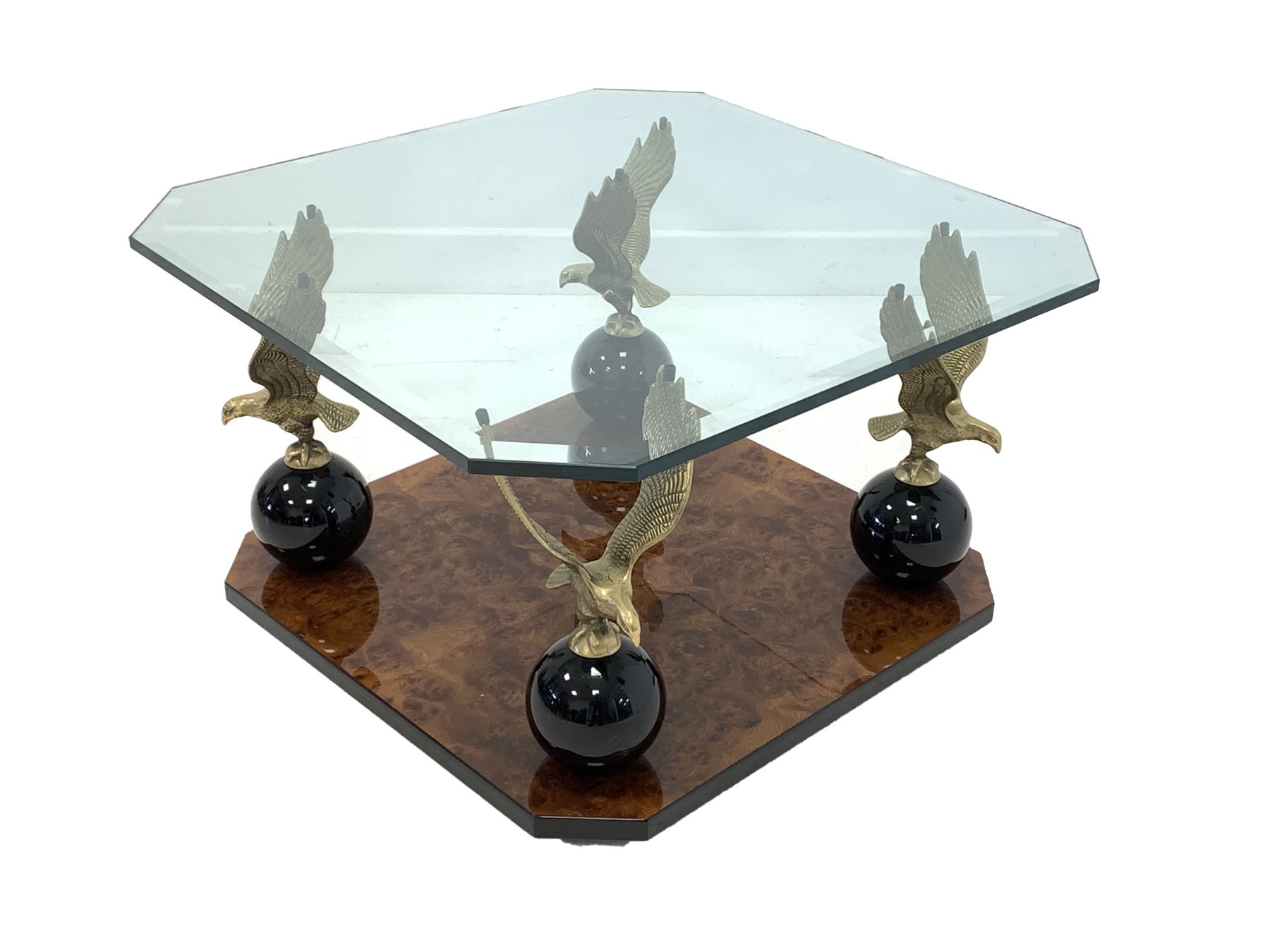 Hollywood Regency coffee table, bevelled glass top raised on four solid gilt brass eagles on a polis