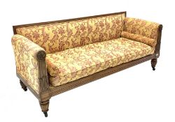 Early 19th century rosewood sofa, moulded crest rail and leaf carved arm terminals with floral round