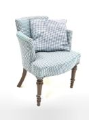 Early 20th century tub shaped armchair, upholstered in blue fabric with lozenge pattern, raised on t