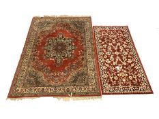 Two machine made Persian design red ground rugs