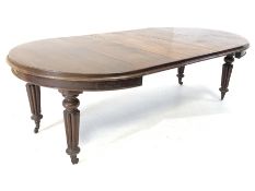 Late Victorian mahogany extending dining table, with 'D' shaped moulded ends and three additional le