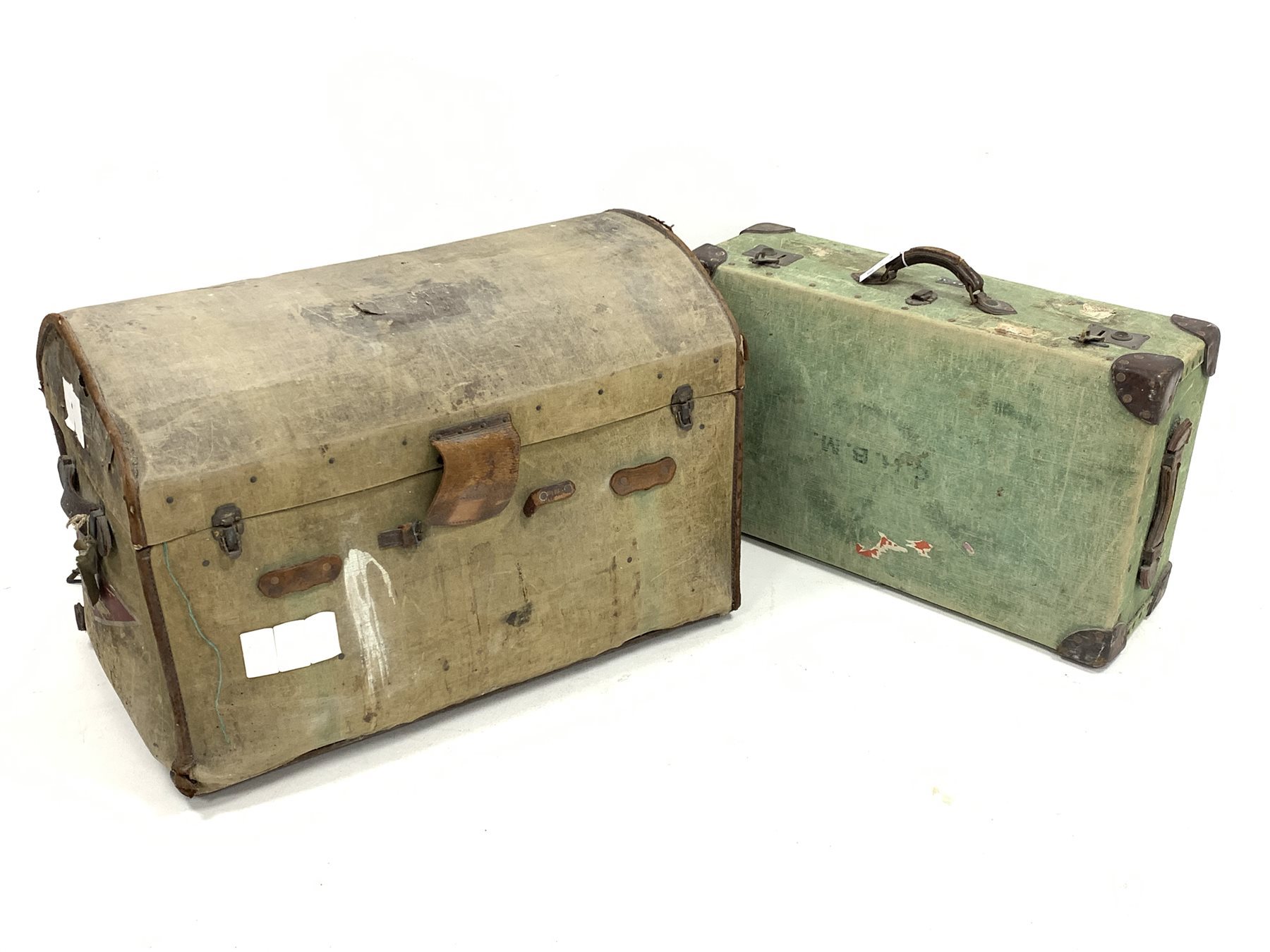 Early 20th century canvas covered dome top travelling trunk, with handle to each end and with old pa