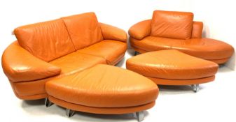 Contemporary Italian lounge suite, comprised of an orange leather two seat sofa, raised on brushed m