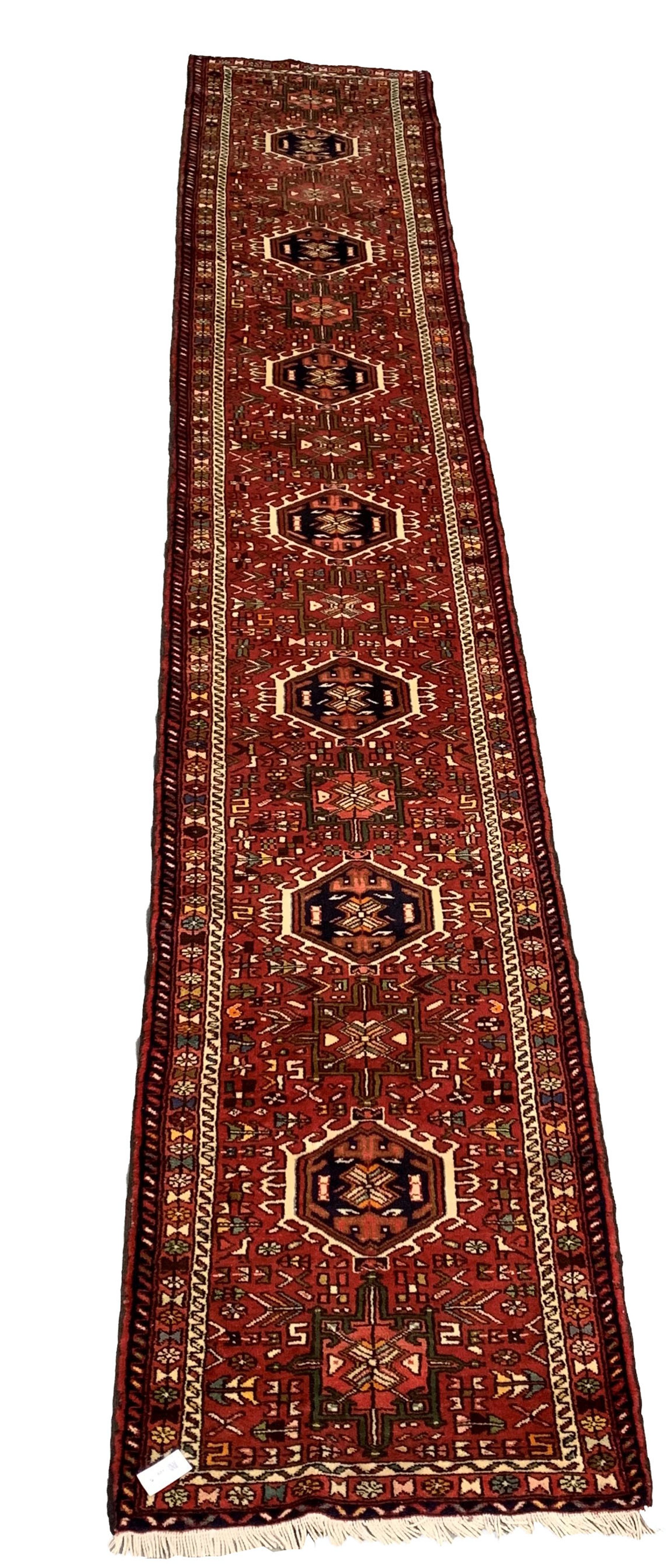 Persian Karajeh runner, seven medallions on red field, guarded border