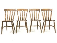 Set of four country elm and beech dining chairs, with shaped seats raised on ring turned supports an