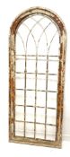 Modern rustic arched window frame, with pine and plywood frame enclosing metal insert