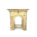 Victorian cast iron fire surround, mantel shelf over scrolled motif leading to a central mask and ar