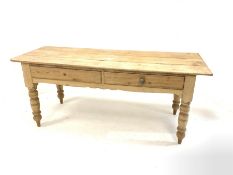 Victorian pine kitchen side table, fitted with two drawers over shaped apron, raised on turned suppo