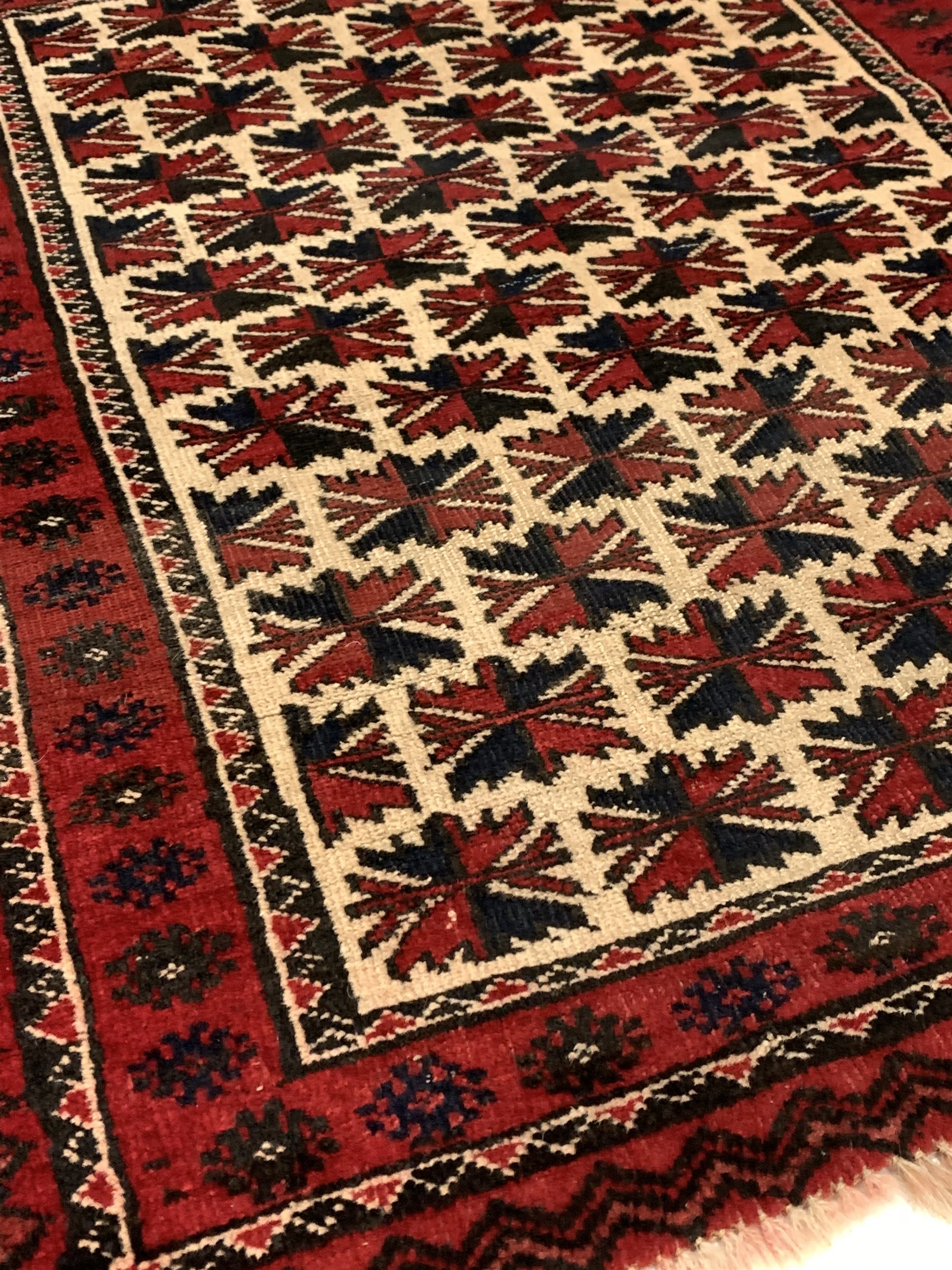 Persian runner rug, with repeating blue design on red field, (250cm x 56cm) together with a Persian - Image 4 of 5
