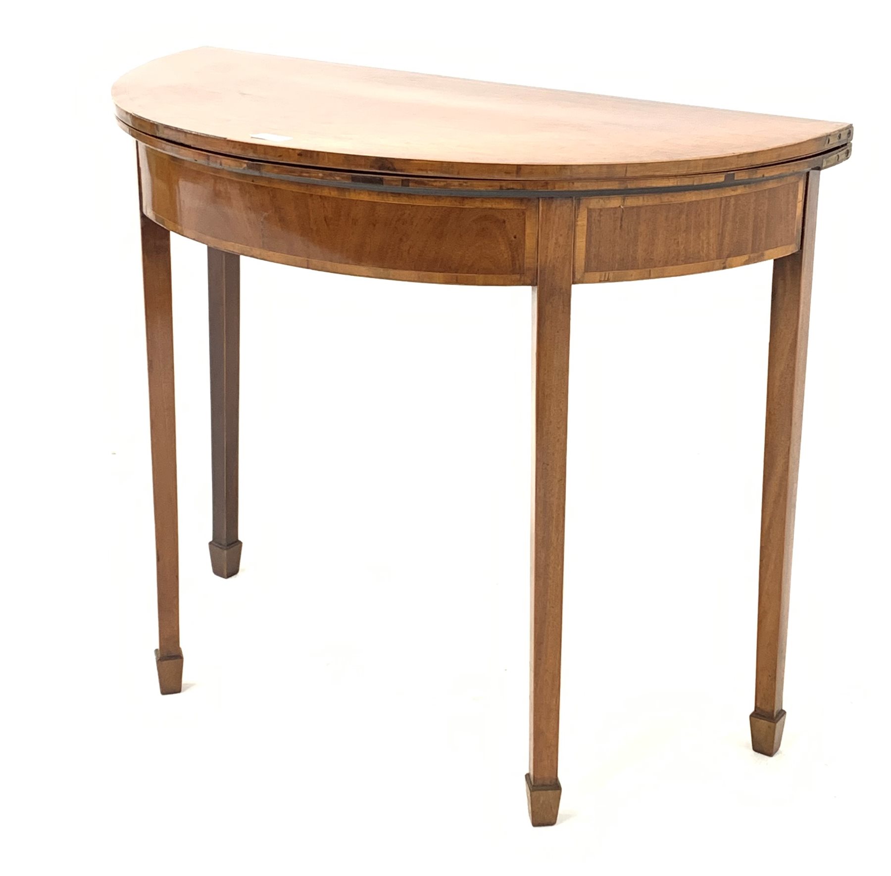 Georgian mahogany demi-lune fold over card table, the crossbanded top lifting to reveal baize lined