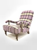 Victorian style low armchair upholstered in chequed wool, with open arms raised on turned oak front