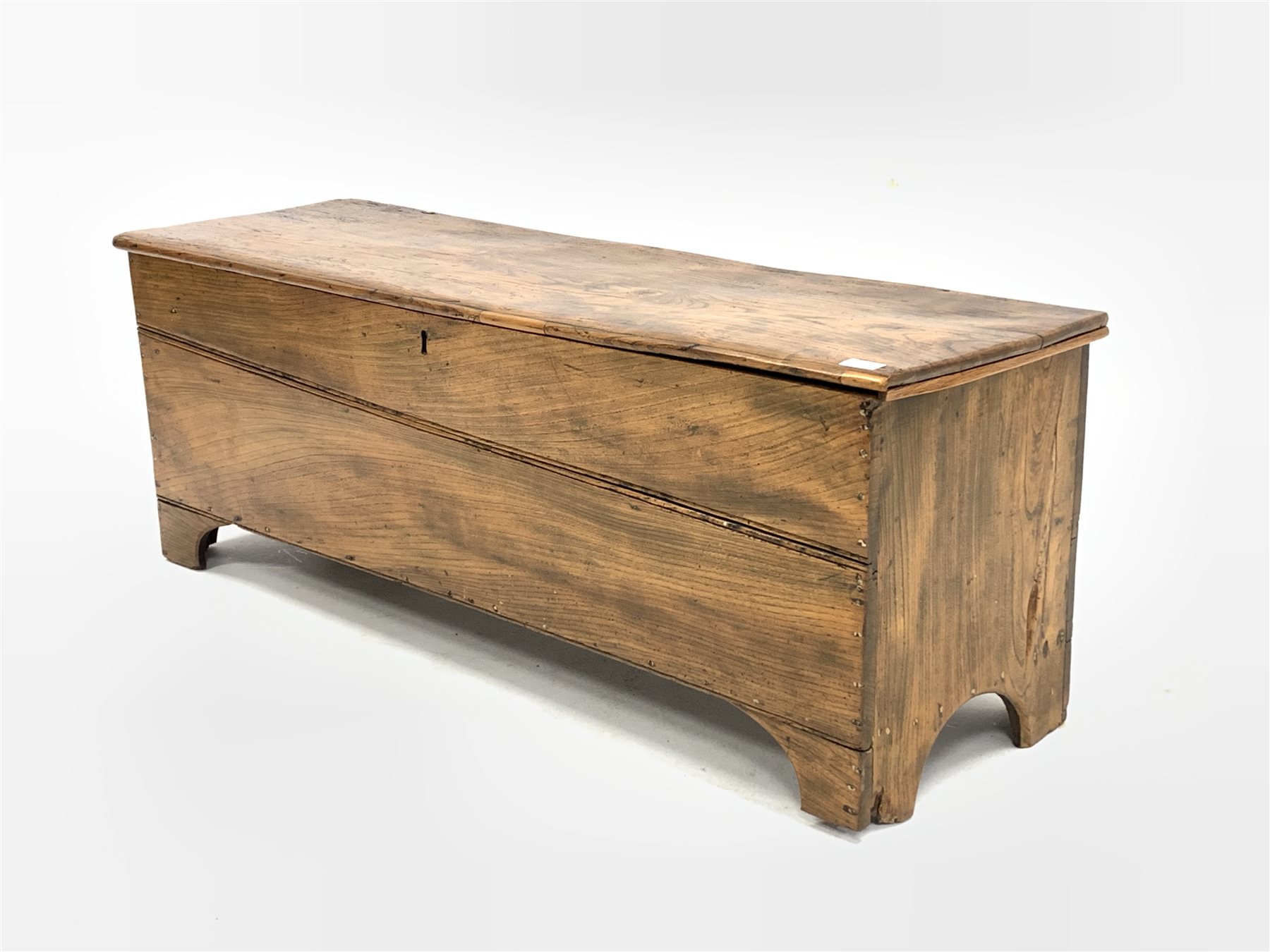 Elm blanket box, hinged lid revealing plain interior, raised on bracket supports